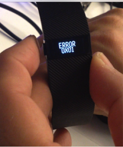Fitbit-Tracker mit dem Text „ERROR 0X01“ auf dem Bildschirm